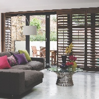 Beautiful Hardwood Shutters on a gliding track system in American Walnut
